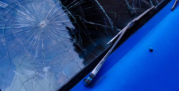 blue car with cracked windshield