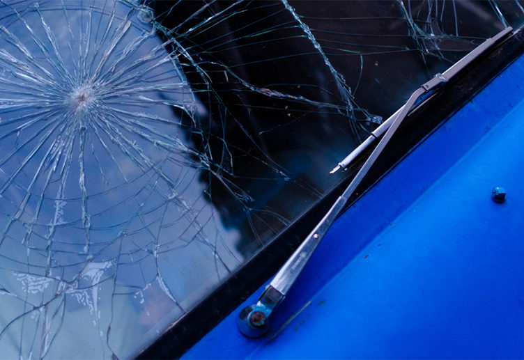 blue car with cracked windshield