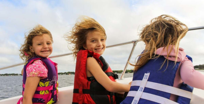 3 girls on boat wearing life vest