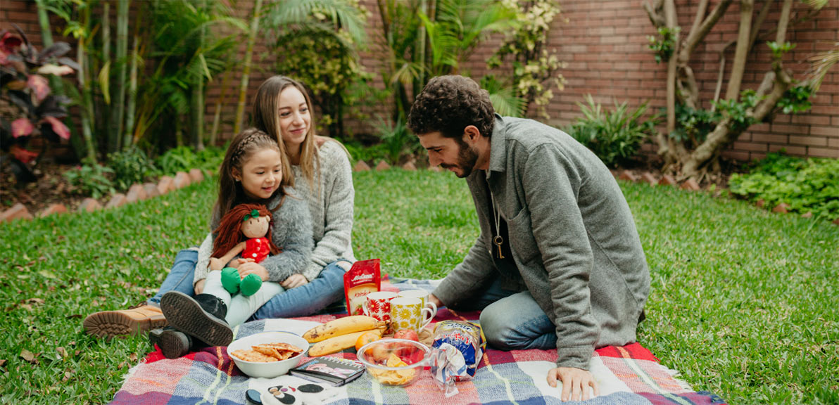 family in backyard having picnic